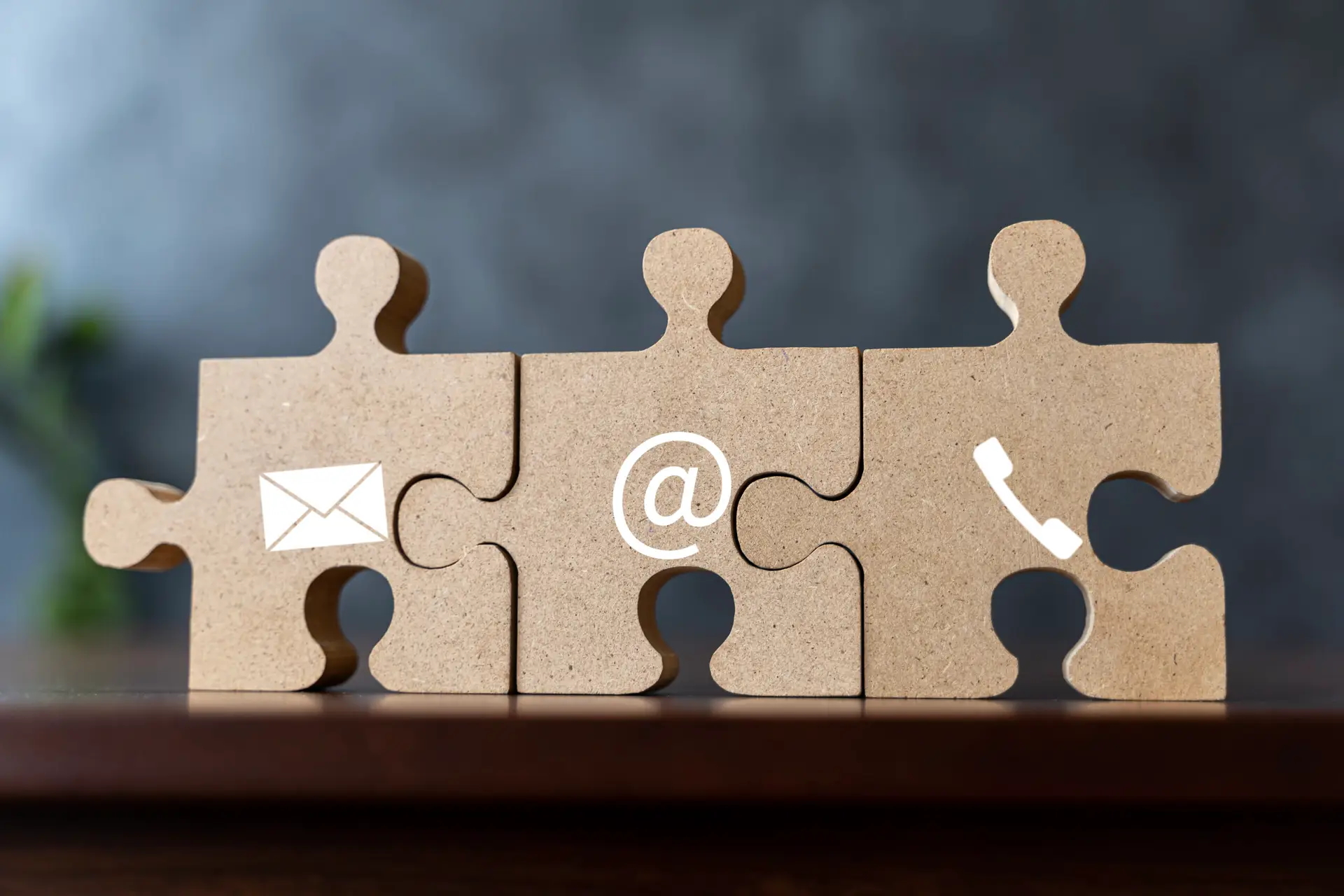 wooden jigsaw puzzle with symbol telephone, email, address. webs